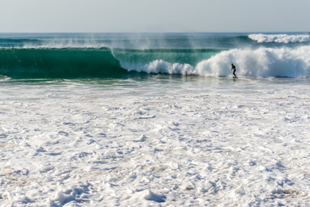 A man surfs a wave, ocean, barrel, sportsの写真素材