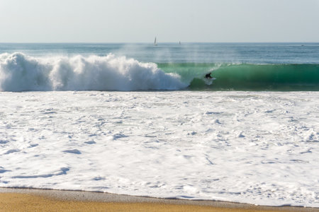 A man surfs a wave, ocean, barrel, sports