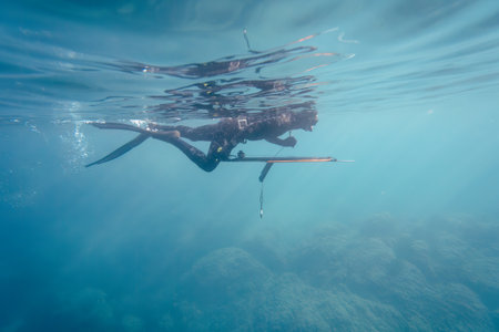 Man spearfishing in wetsuit, Mediterranean
