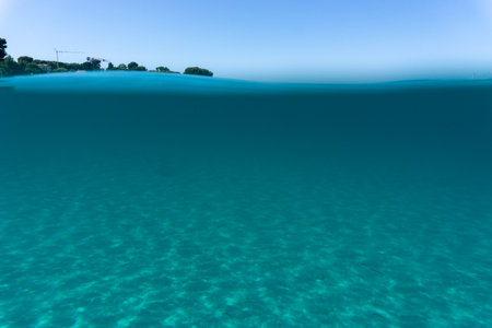 Beneath surface sand sun blue skyの写真素材