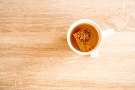 A mug of tea on a wooden tableの写真素材