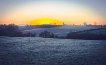 A wintery landscape in the United Kingdom at sunriseの写真素材