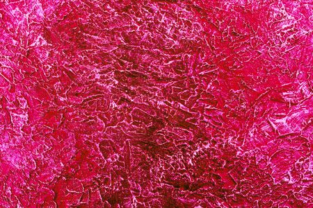 The texture of the wall is painted in a dark pink color. Background.