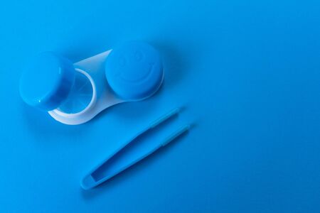 Blue container for contact lenses on blue backgroundの写真素材