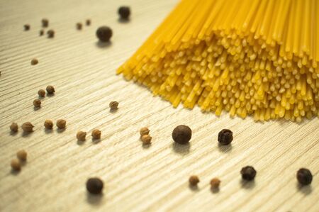 Spaghetti raw and spices on the tableの写真素材