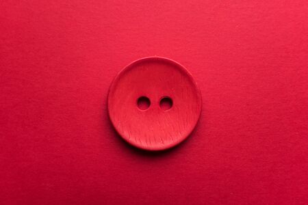 Red button on red backgroundの写真素材