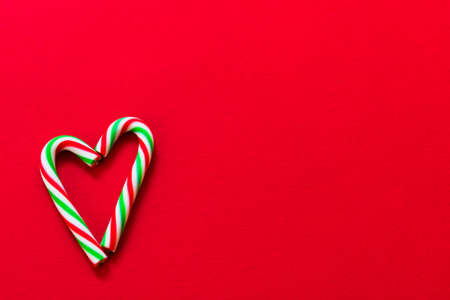 Heart made of Christmas candies on a red background. Copy space.の写真素材