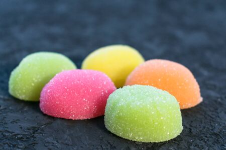 Marmalade as a background. Texture. Jelly sweet candies on a black background. The texture of the...