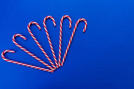 A lot of Christmas candies on a blue background. Copy space.の写真素材