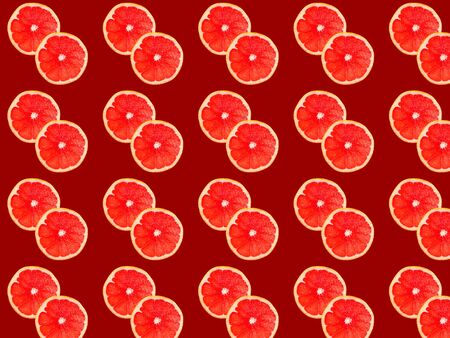 Seamless photo pattern of grapefruit slices on a red background. Seamless pattern for your design.