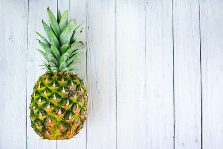 Pineapple on a white wooden background. Copy space.の写真素材