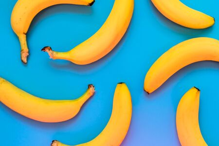 Background of yellow bananas on a blue background.の写真素材