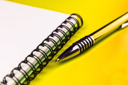 Notebook and yellow pen on a yellow background. Composition yellow on yellow.の写真素材