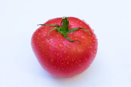 One tomato on a white background.Close-up.の写真素材