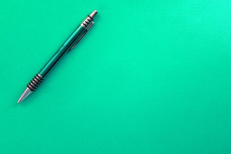 Green pen on a green background. Copy space.の写真素材