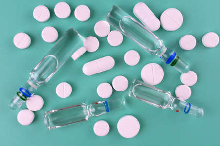 Pills and ampoules for injections on  blueの写真素材