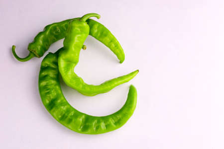 Green chili peppers on a white background. Copy space.のeditorial素材
