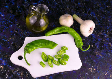 Green pepper paprika, garlic and olive oil on the table.の写真素材