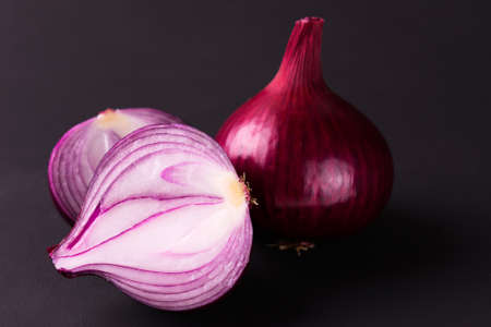 Red onion in a cut on a black background.の写真素材