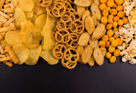 Junk food. A lot of junk food on a black background. Copy space.の写真素材