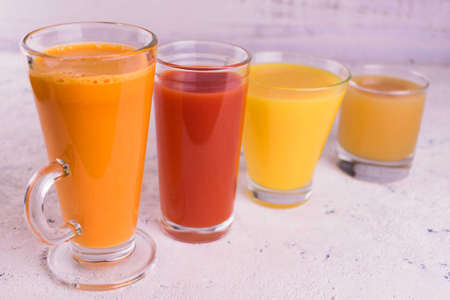 Glasses with fruit and vegetable juices on a white background.の写真素材