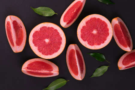 Sliced ââgrapefruit on a black background. Flat lay.の写真素材