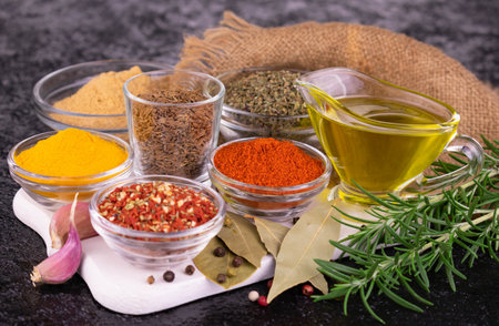 Many different spices and sauces on a black background.