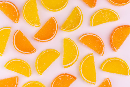 Background of gummy candies in the form of orange and lemon slices.の写真素材
