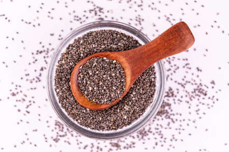 Chia seeds in a plate on a white background. Flat lay.