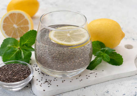 A glass of water with chia seeds and lemon on a white background. Slimming drink.の写真素材