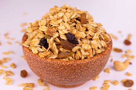 Granola in a bowl of coconut on a white background. Close-up.の写真素材