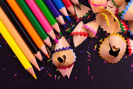 Pencils of different colors on a black background. Top view. Bright background from pencils.の写真素材