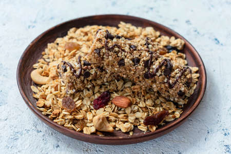Healthy granola on a plate, and granola bars.の写真素材
