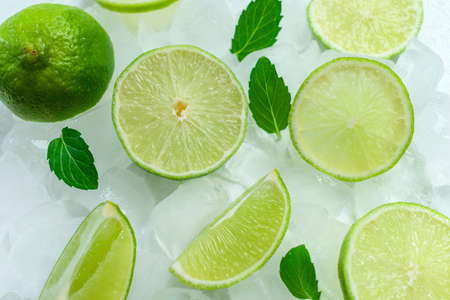 Lime slices and mint leaves on ice. View from above.の写真素材