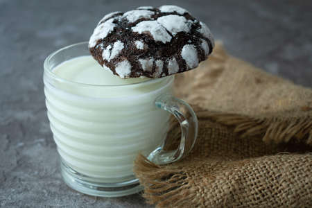 A cup of milk and homemade chocolate chip cookies.