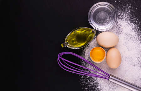 Ingredients for the dough. Flour, egg and olive oil. Copy space.