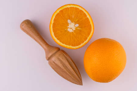 Orange and wooden juicer on a white background. Flat lay.の写真素材