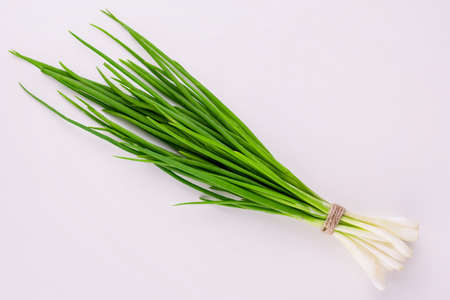 A bunch of green onions on a white background. Flat lay.の写真素材