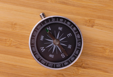 Classic round compass on a wooden background. Travel concept. View from above.の写真素材
