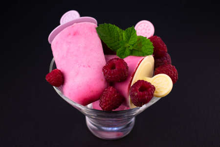 Homemade raspberry ice cream on a black background. Close-up.の写真素材