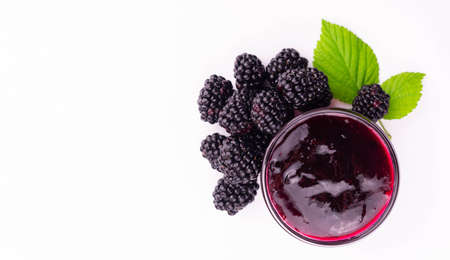 Blackberry jam on a white background. Copy space. Flat lei.