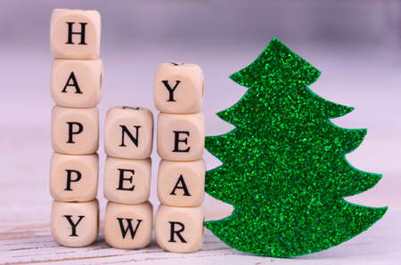 Happy new year lettering and little green Christmas tree.Close-up.の写真素材