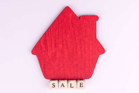 Red wooden house and the inscription is for sale.の写真素材