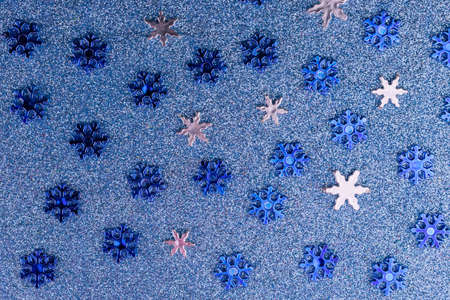 Snowflakes on a shiny blue background.の写真素材