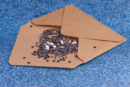Open paper envelope with shining stars on blue backgroundの写真素材