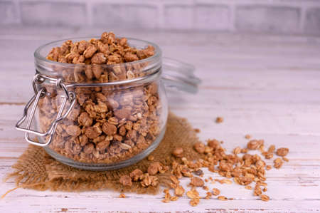 Granola in a jar. Healthy breakfast concept.