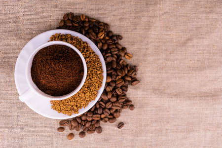 Coffee of different processing, ground, grains and granules in a cup. view from above.