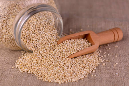 Quinoa seeds poured out of a jar. close-up.の写真素材