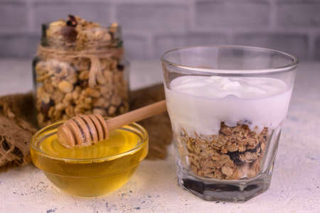 Greek yogurt dessert with granola and honey.の写真素材