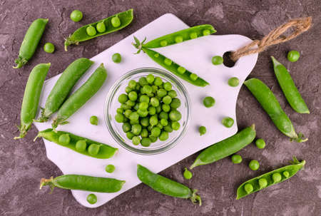 Fresh green peas on a white wooden board.Lei flat.の写真素材